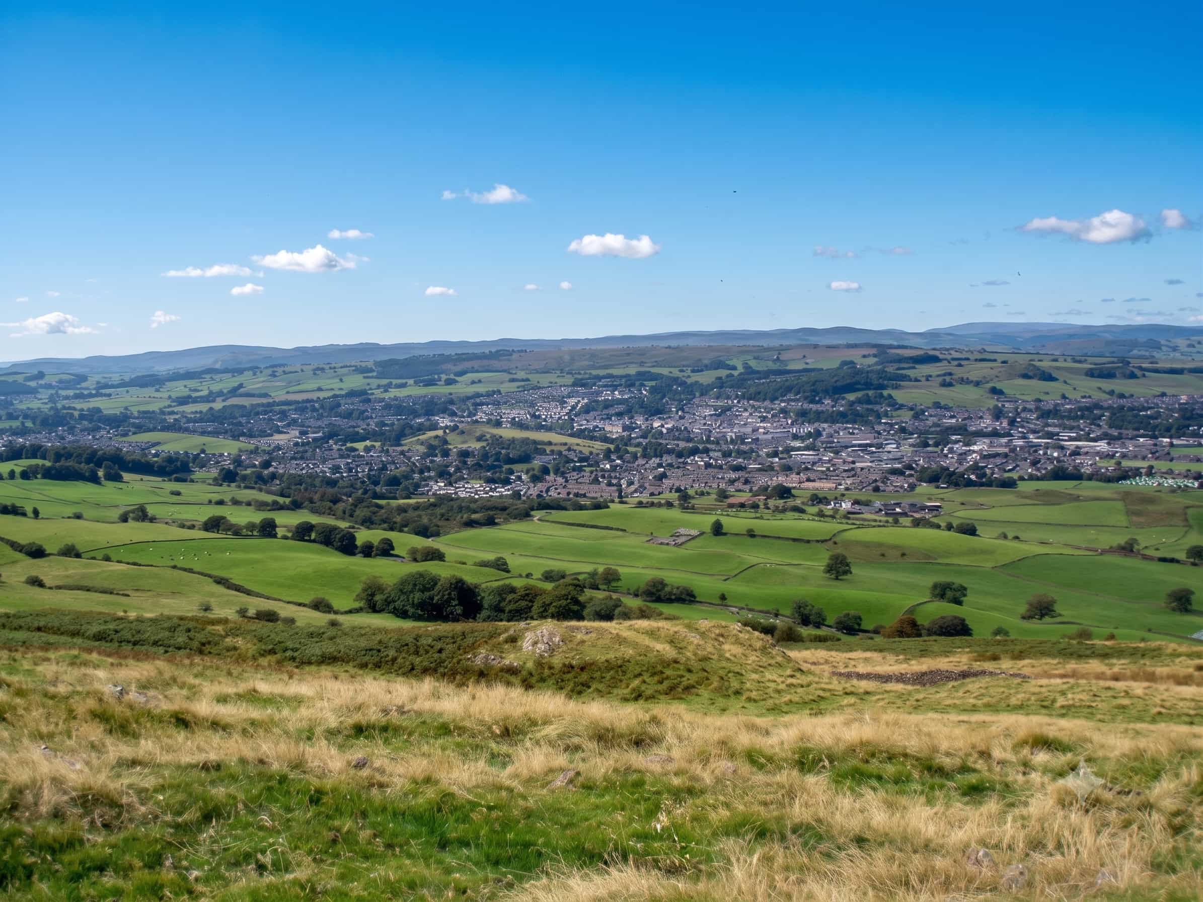 The view over Kendal and the Kent valley from the grassy top of Benson Knott, Lake District