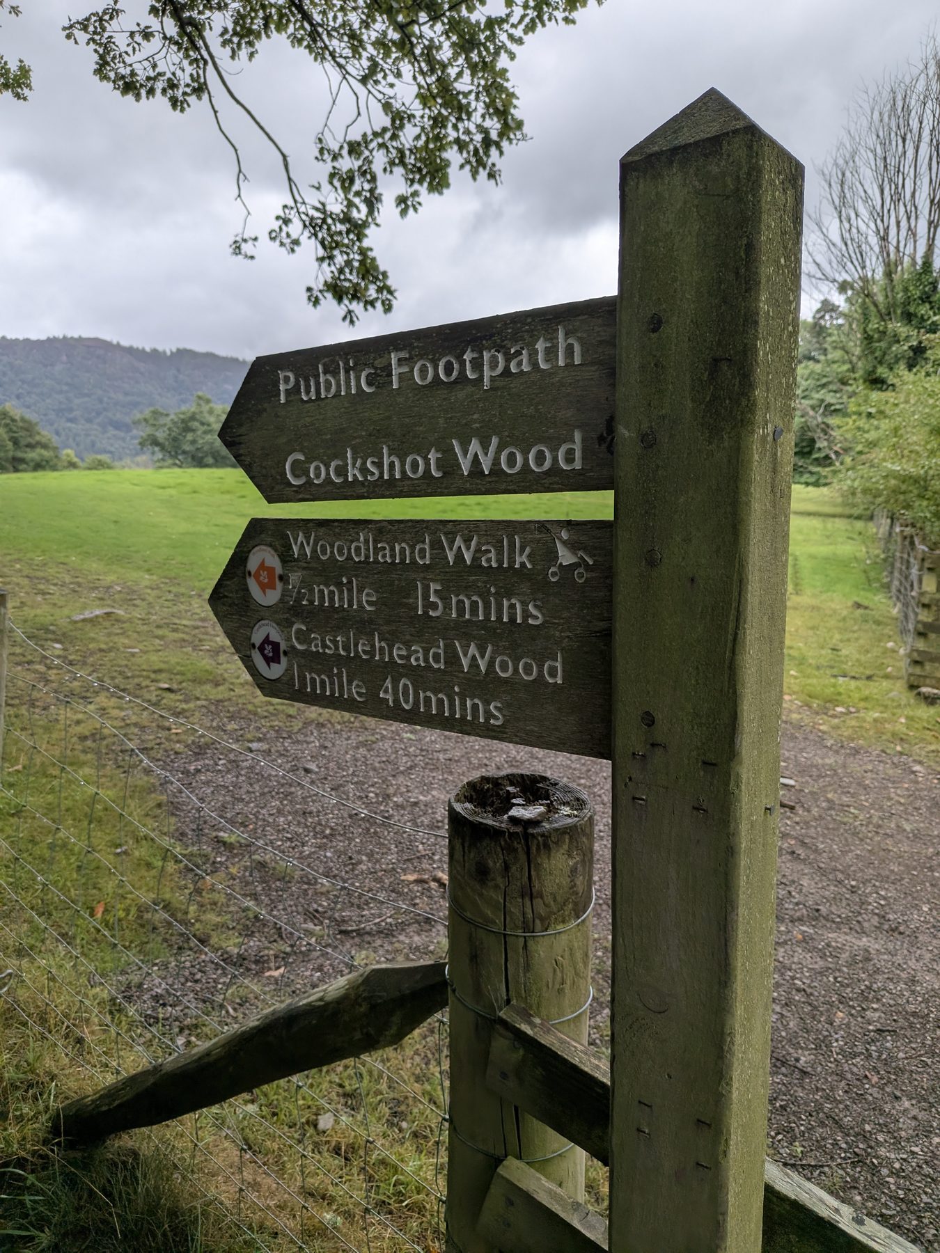 The National Trust fingerpost at the path crossroads on the Castle Head walk, Keswick