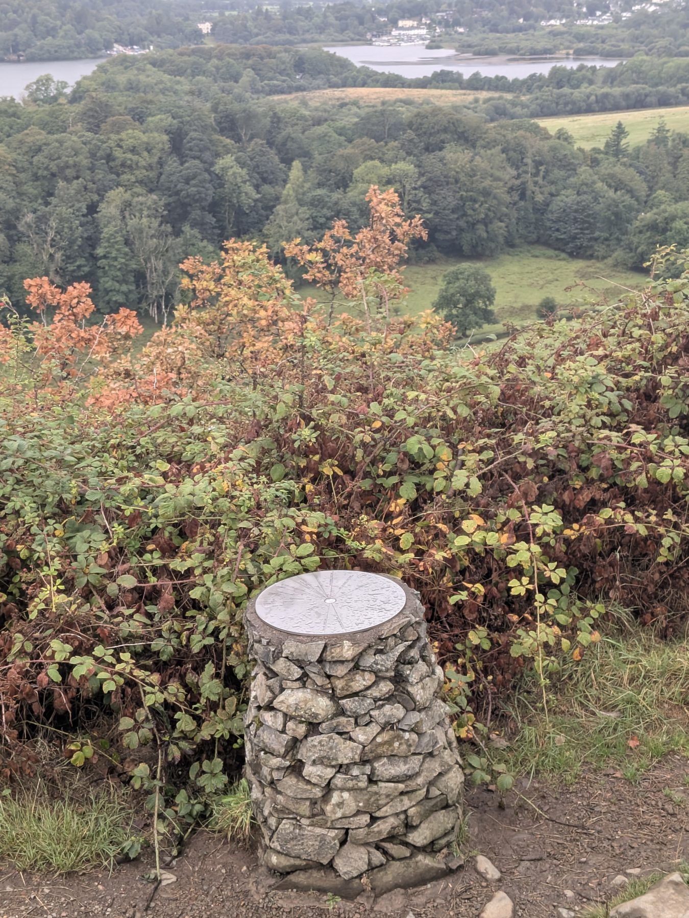 The summit of Castle Head with its bench and toposcope above Derwentwater, Keswick