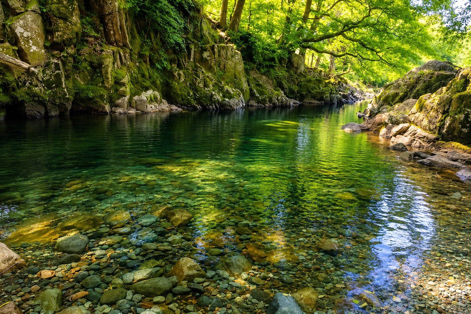 Gill Force, a deep, clear green pool on the River Esk in Eskdale, enclosed by rock and woodland