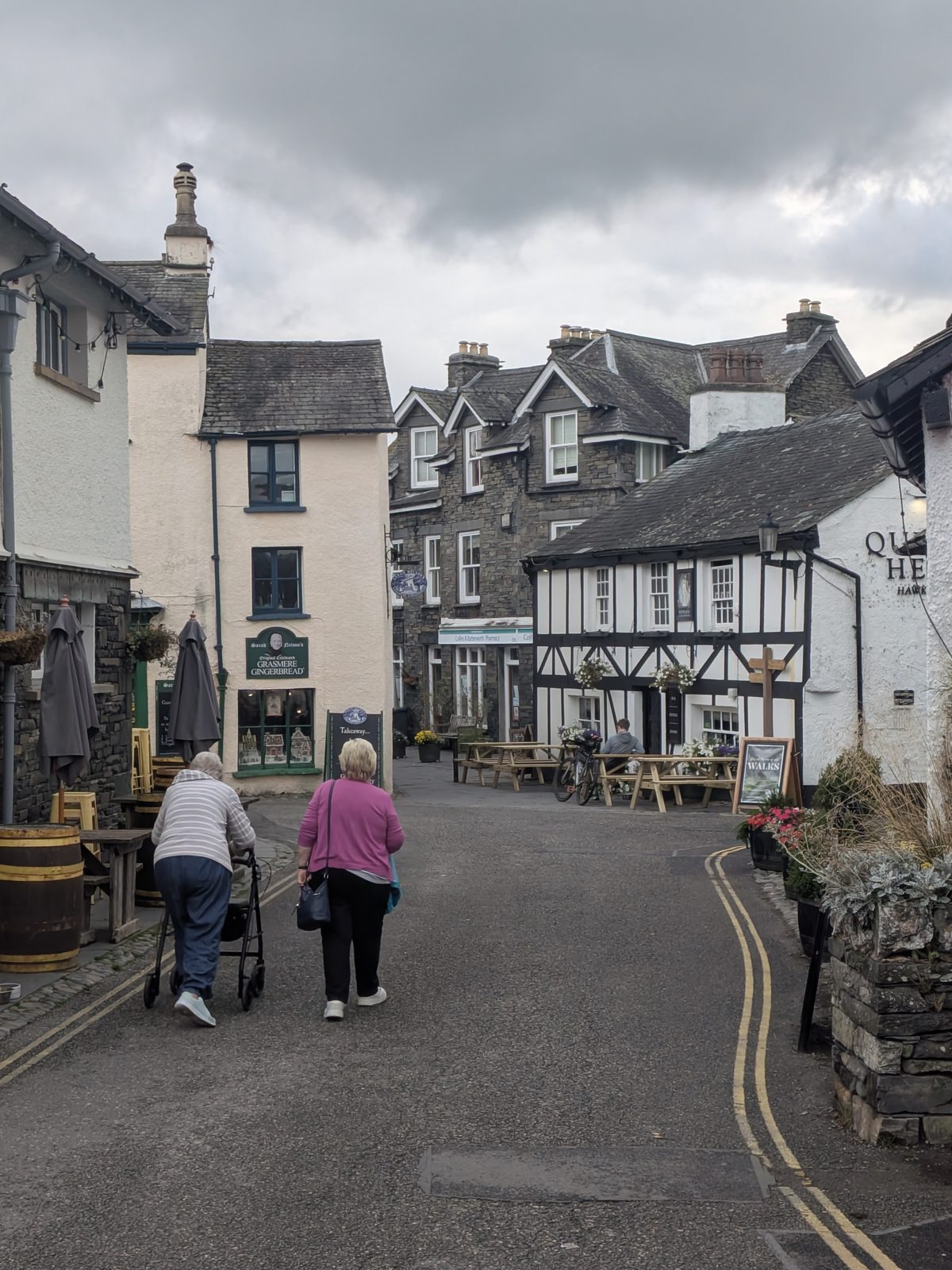 The centre of Hawkshead village, whitewashed and timbered buildings along the lane