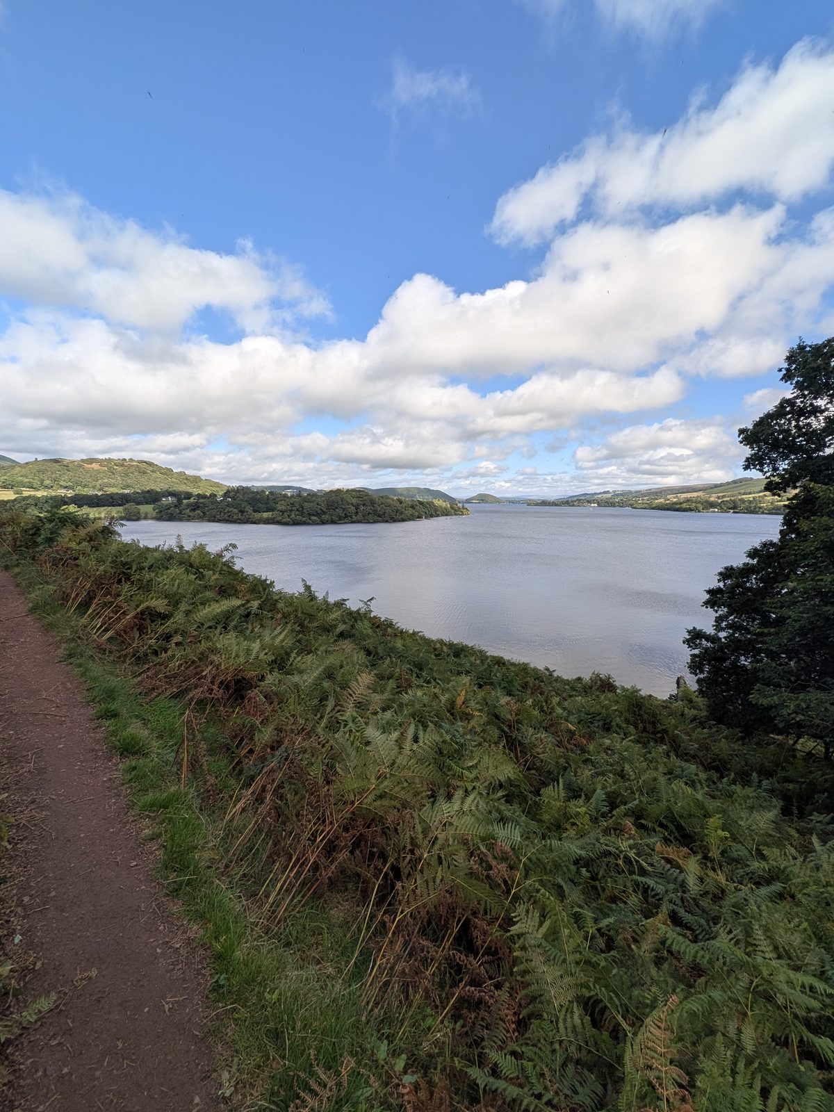 A narrow path through bracken above Ullswater, the lake stretching away below