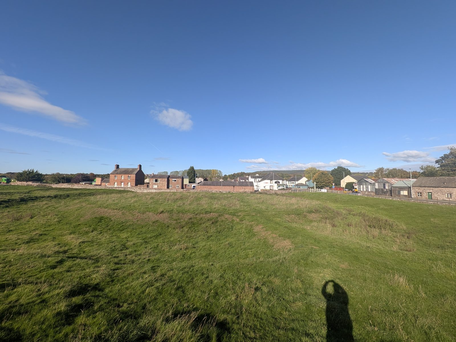 Looking across King Arthur's Round Table henge to the houses of Eamont Bridge, near Penrith