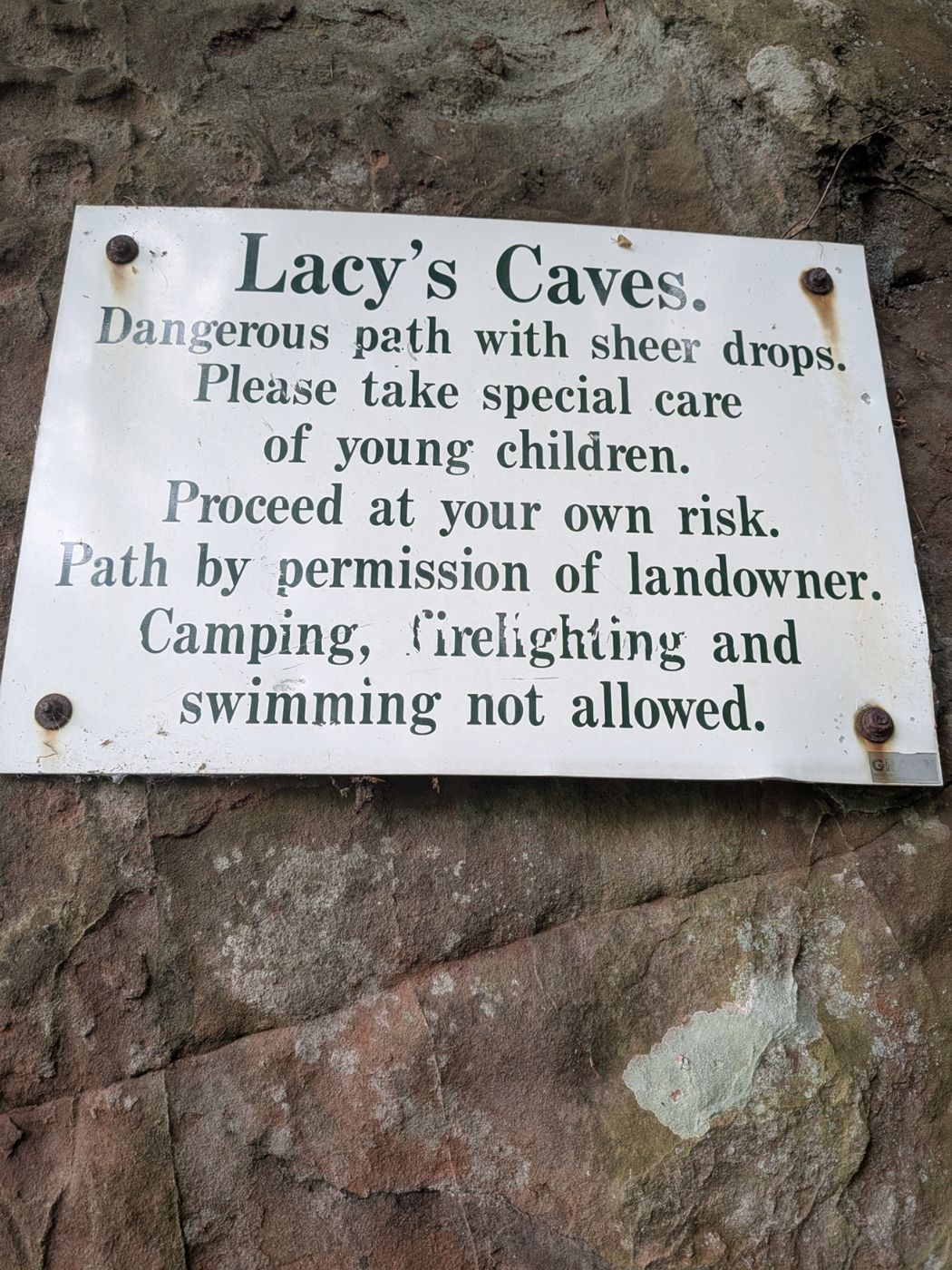 The landowner's warning sign at Lacy's Caves — sheer drops, no camping, fires or swimming, River Eden Kirkoswald