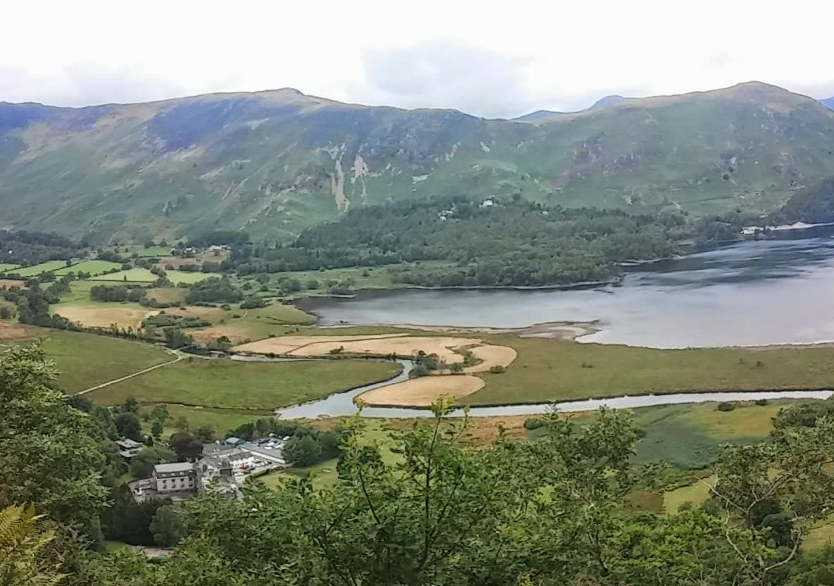 The southern end of Derwentwater where the River Derwent winds in through the fields from Borrowdale