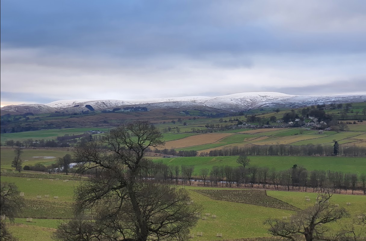 The view from Lowther's Western Terrace across the Lowther valley to snow-covered Lakeland fells in winter