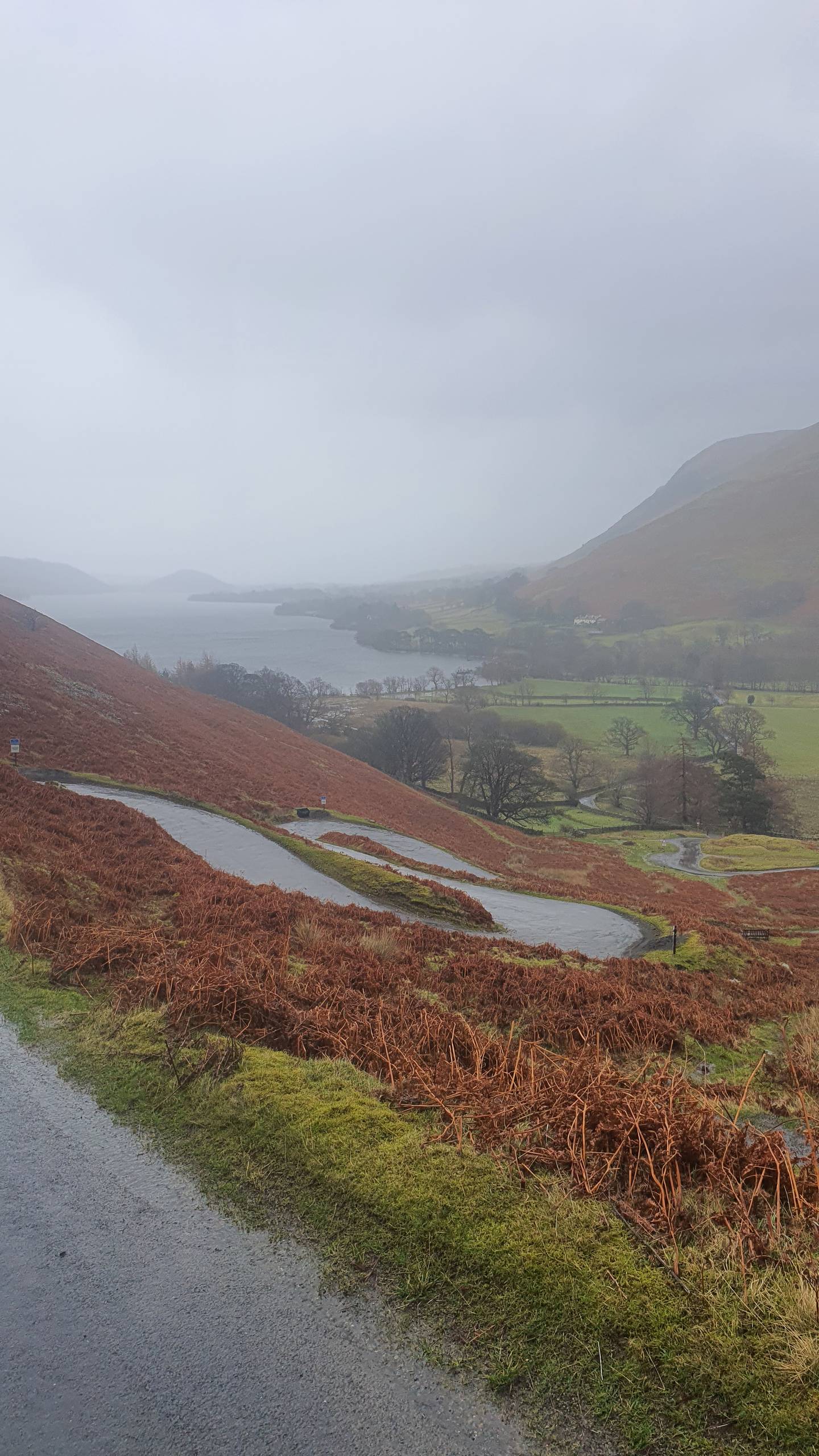 The switchback road at Martindale near Howtown, with Ullswater in the distance, Lake District