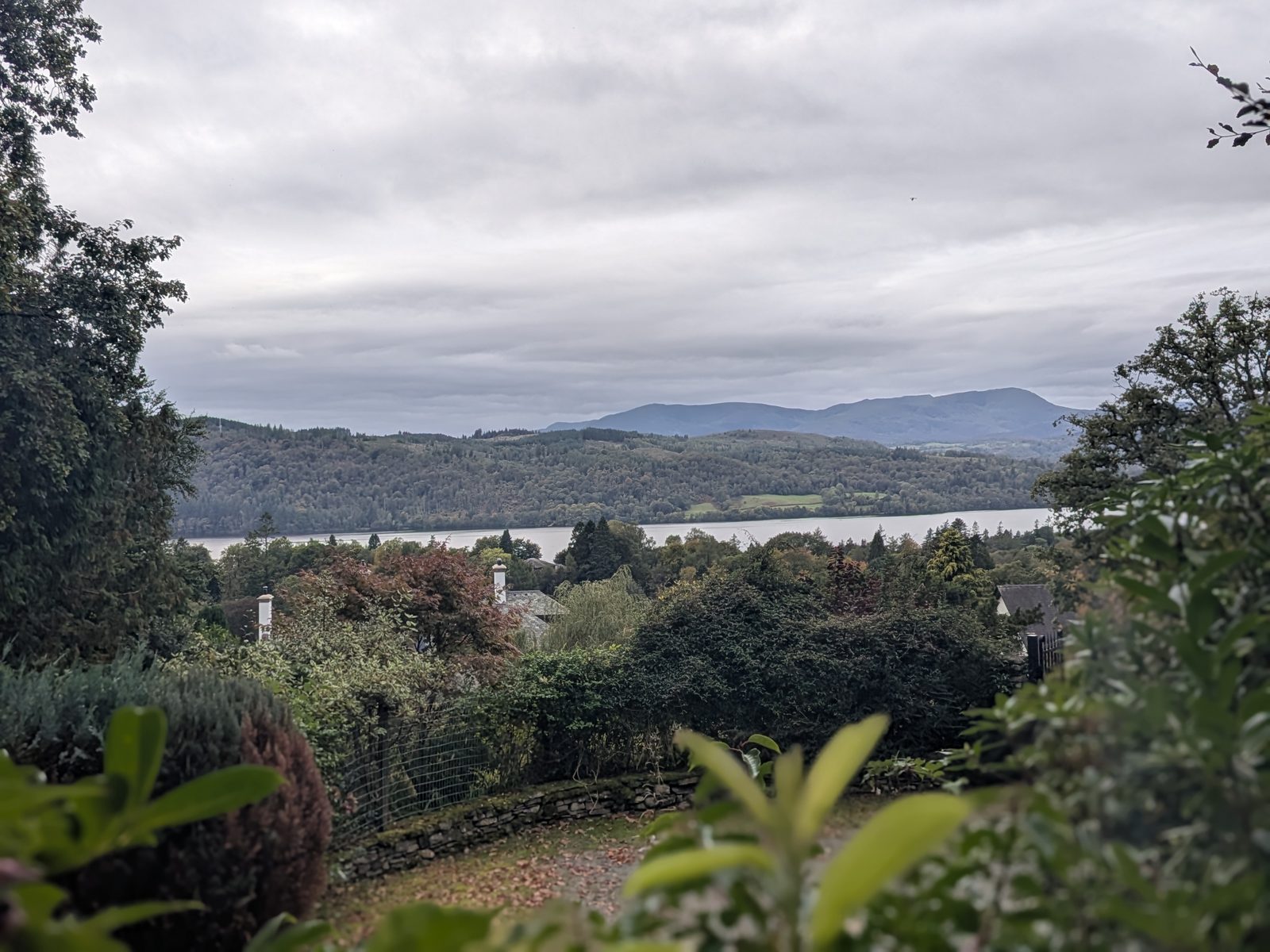 Windermere and the fells seen over gardens from the path back into Windermere town