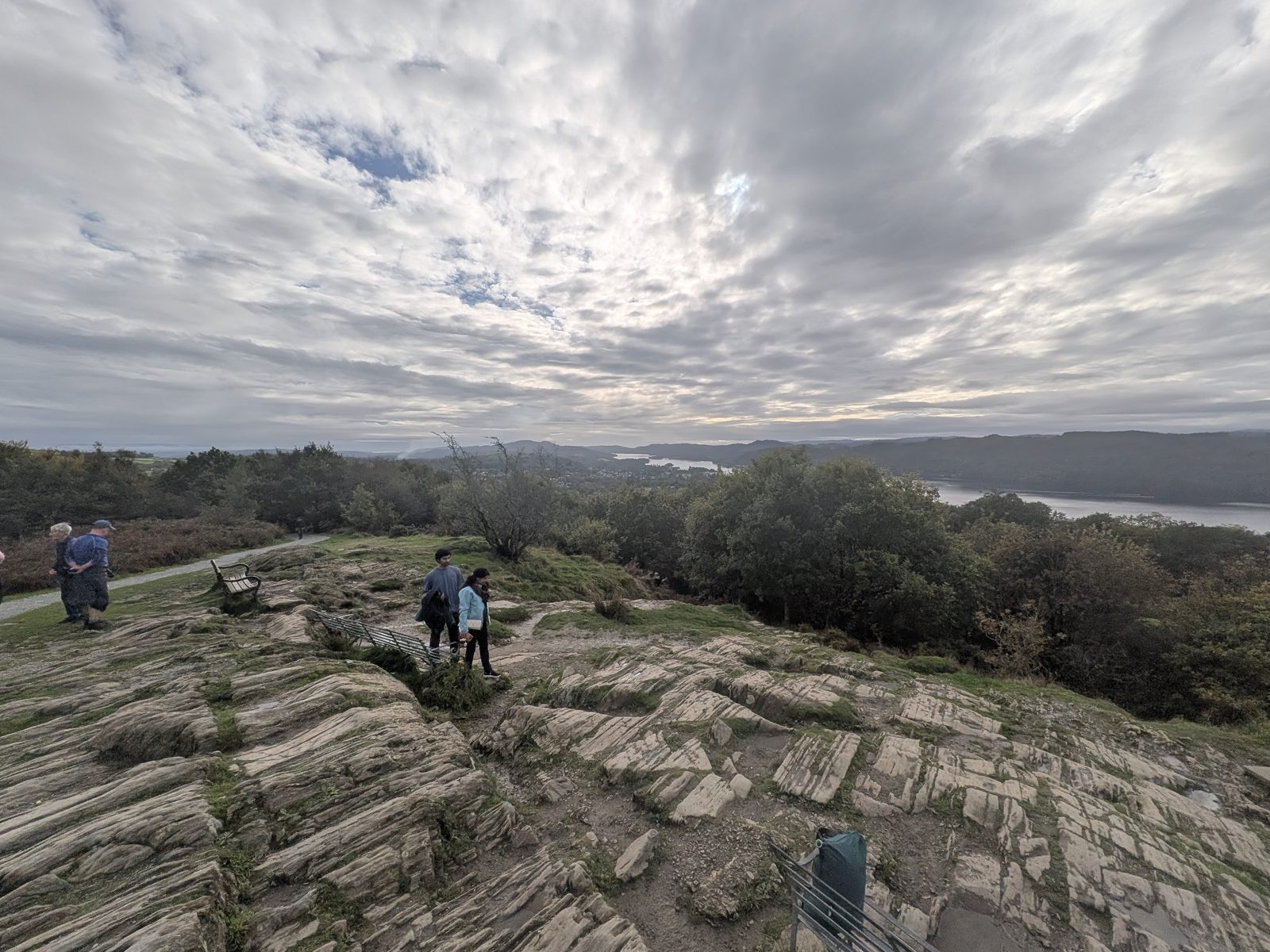 Rock slabs and benches on the top of Orrest Head under a big sky