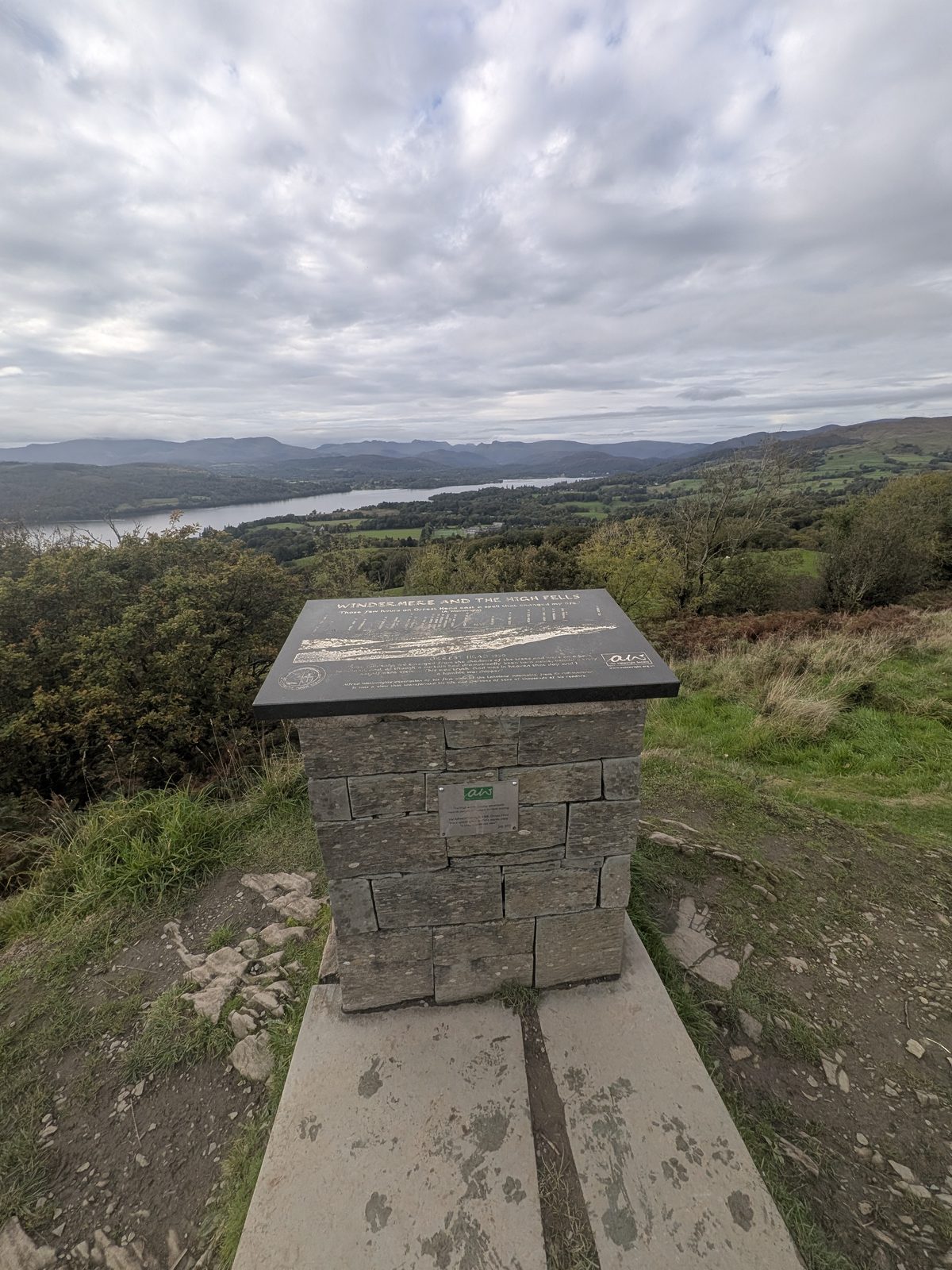 The stone viewfinder plinth on the summit of Orrest Head, with Windermere beyond