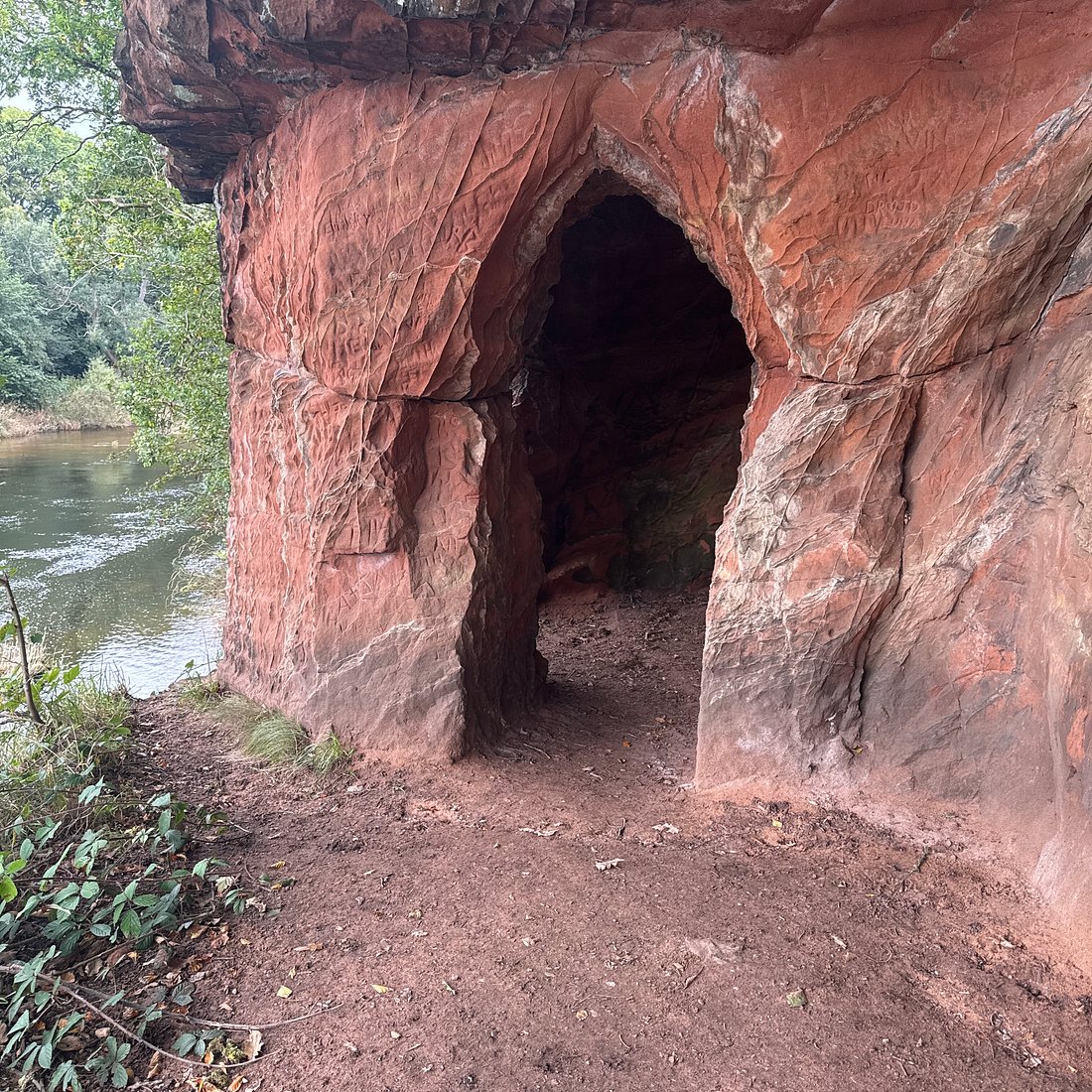 Lacy's Caves cut into the red-sandstone river cliff above the River Eden near Kirkoswald, Eden Valley, Lake District