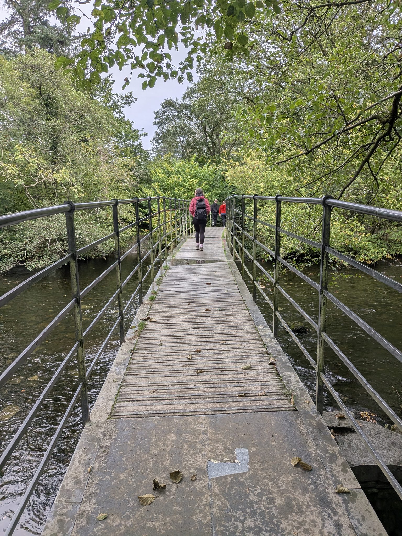 Ellie crossing the footbridge over the River Rothay on the way to Rydal Cave