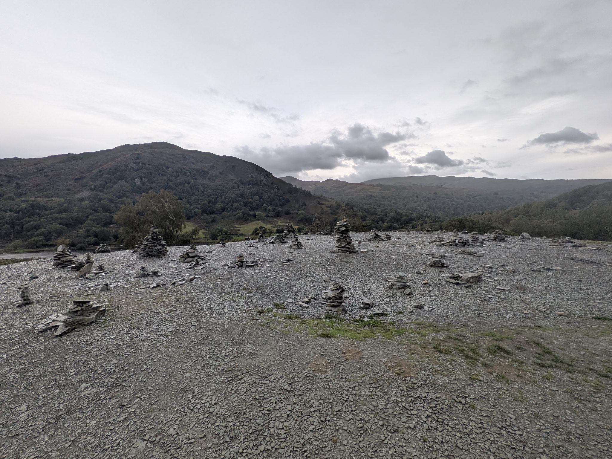 Visitor-built stone stacks on the quarry spoil outside Rydal Cave