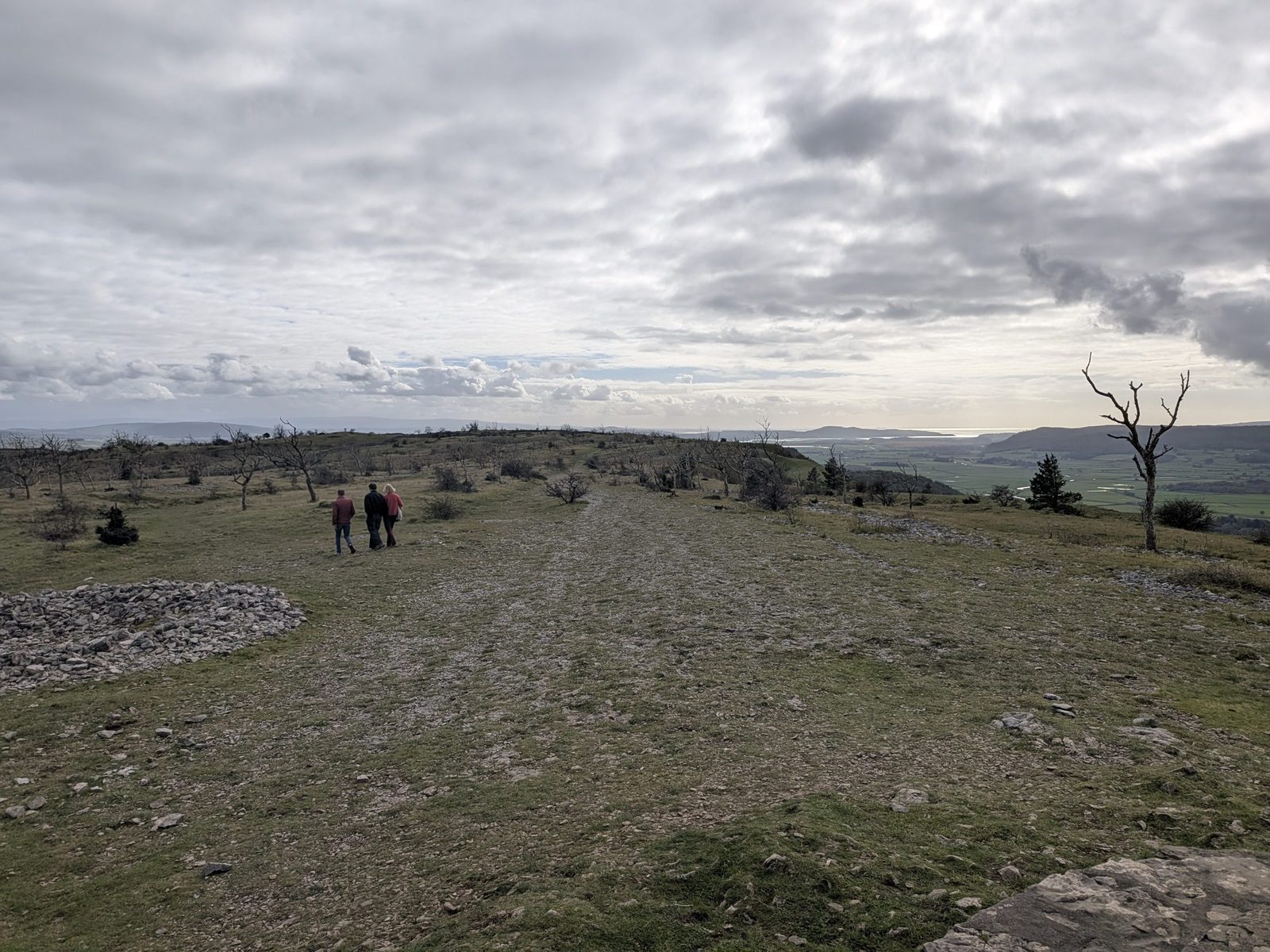 The view from the Mushroom on Scout Scar over the limestone top, with walkers in the distance