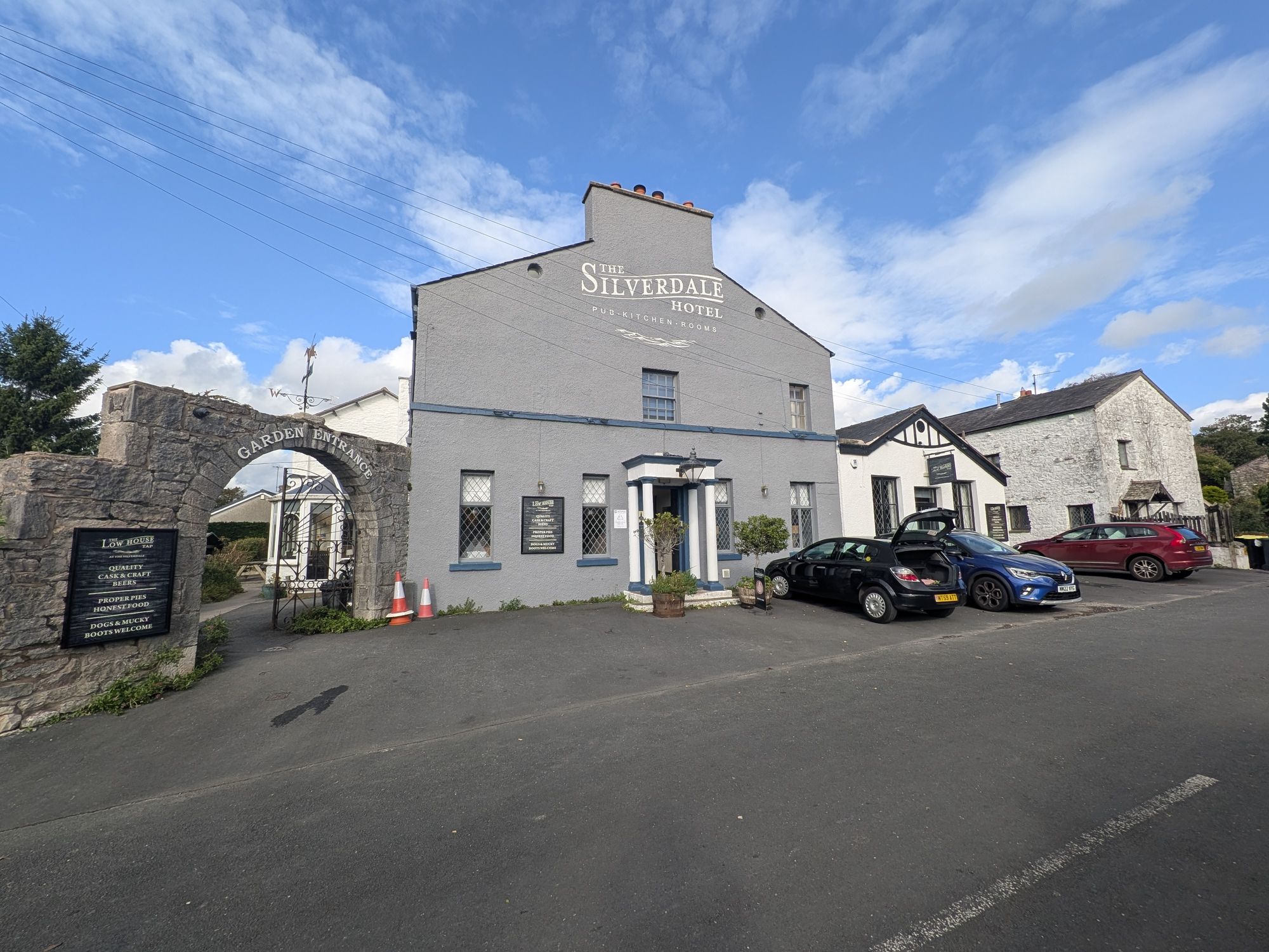 The grey-painted Silverdale Hotel on Shore Road, with a stone arch signed Garden Entrance and a board for The Low House Tap