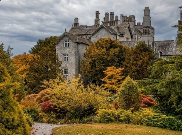 Sizergh Castle and its pele tower rising above the gardens in autumn colour, near Kendal, Lake District
