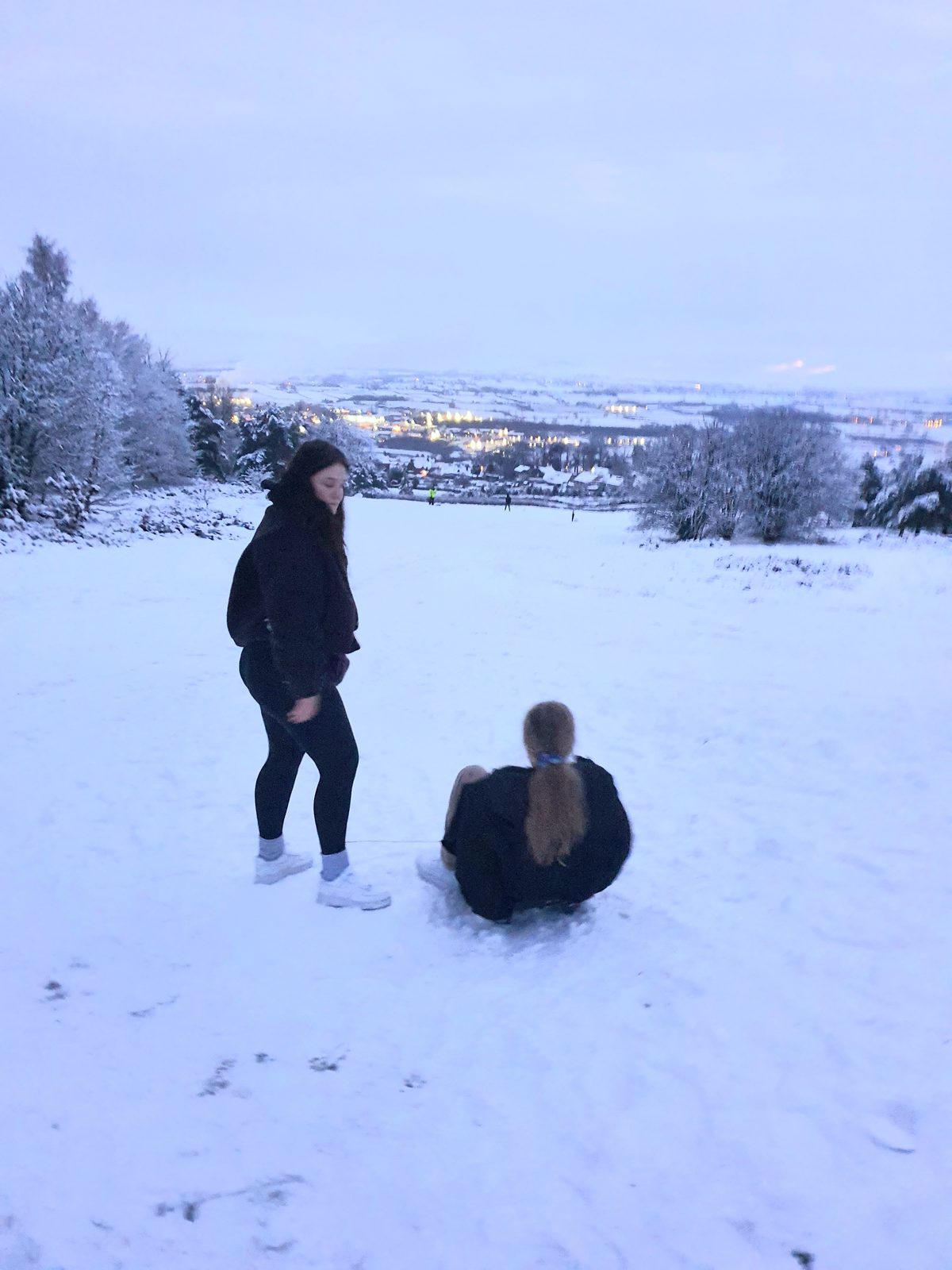 Sledging on the snow-covered slopes of the golf course above Penrith