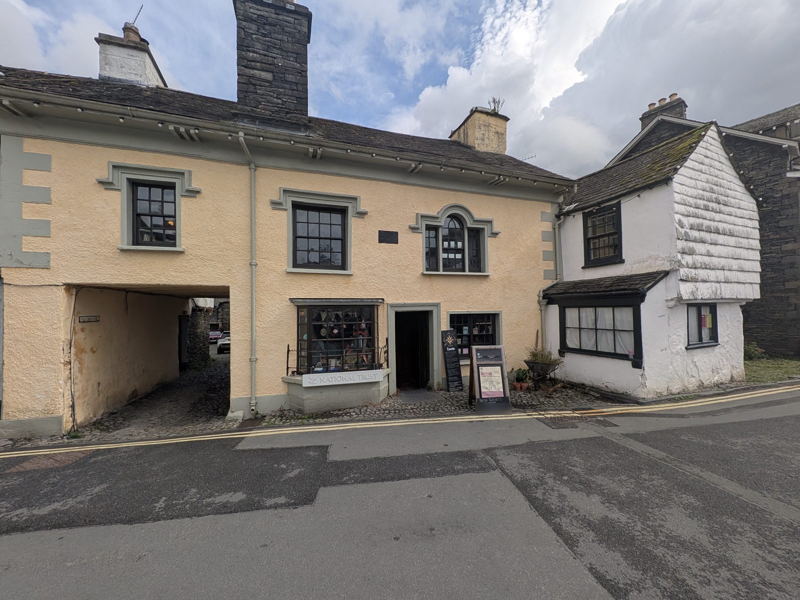 Tabitha Twitchit's Bookshop on Main Street, Hawkshead, with the National Trust sign and A-board outside