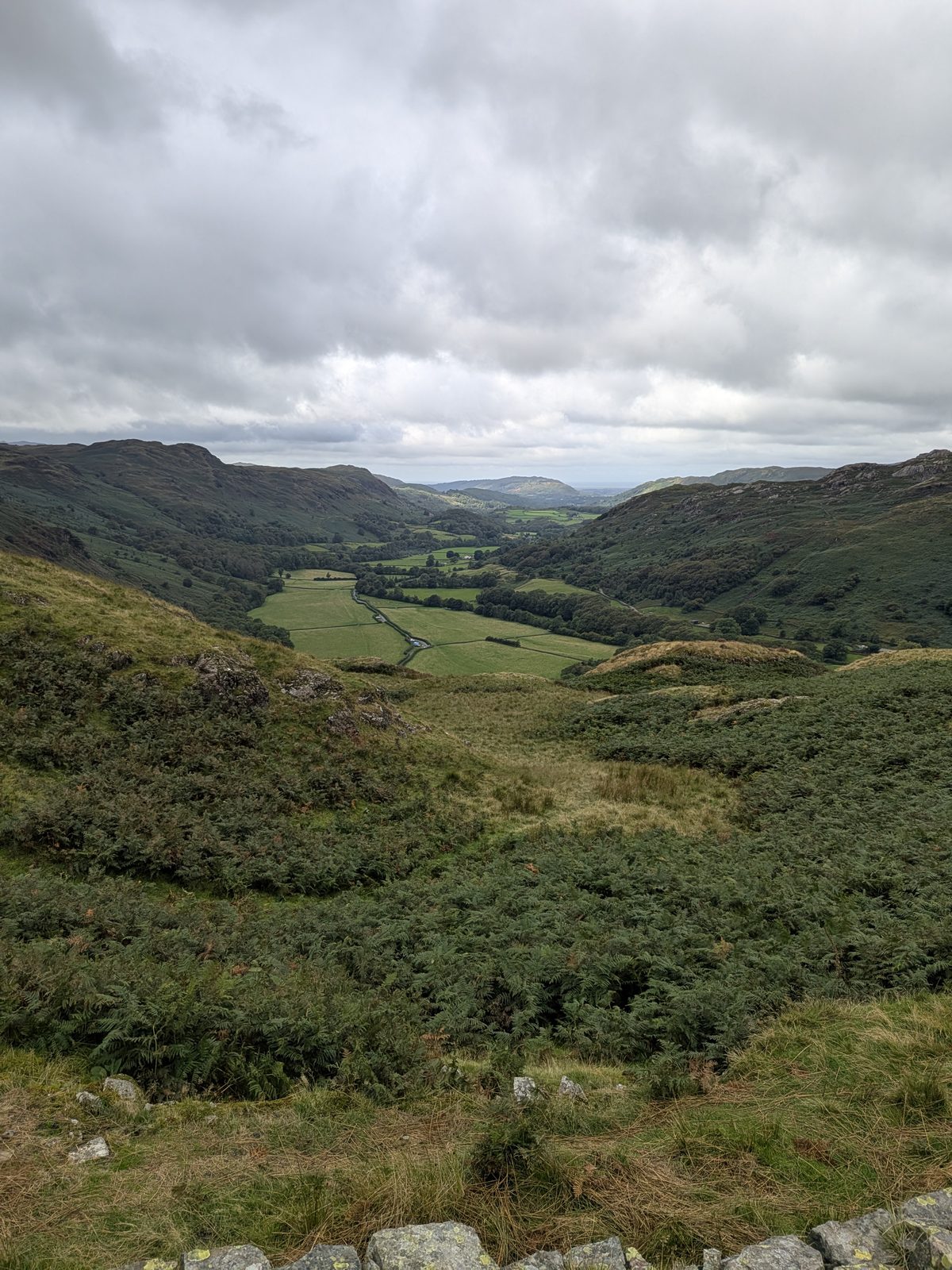The view down Eskdale from the walls of Hardknott Roman Fort, green fields on the valley floor and fells on both sides