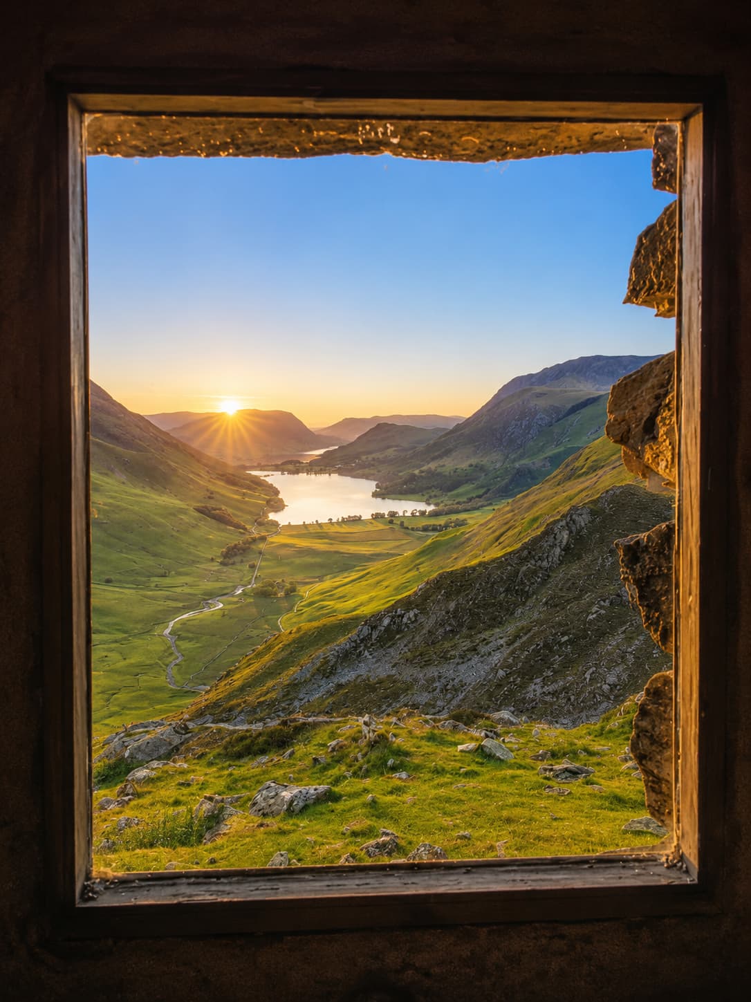 Warnscale Head Bothy high above Buttermere, with its famous window framing the lake, Lake District