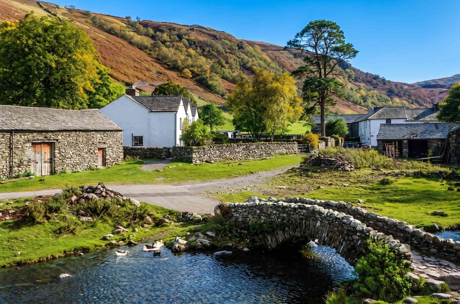 The old farm buildings of Watendlath hamlet beside the tarn, Borrowdale, Lake District